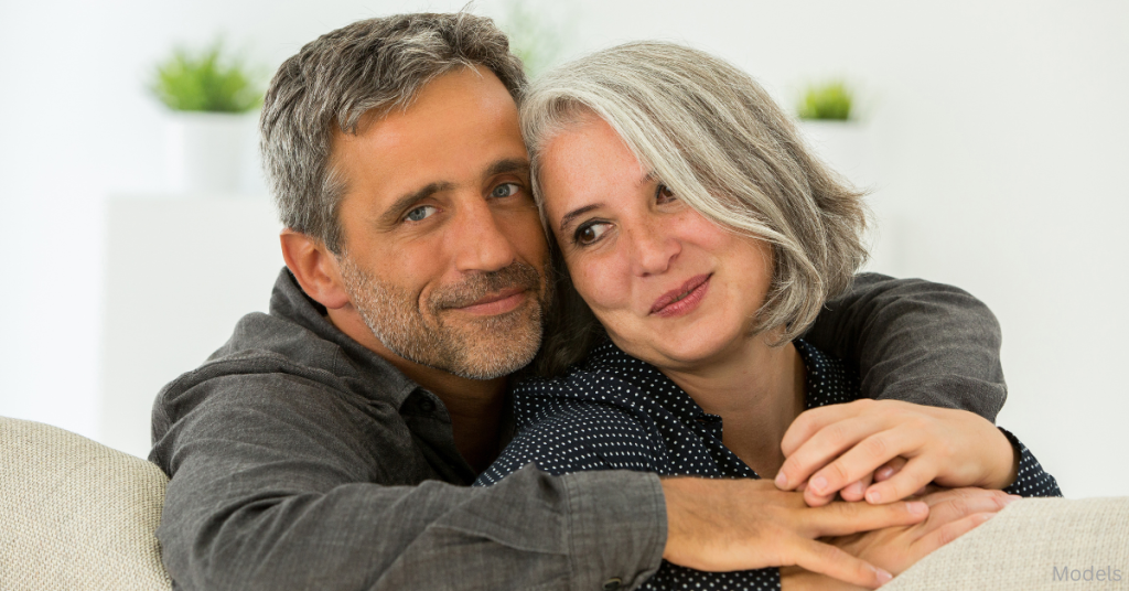 Older man and woman hugging